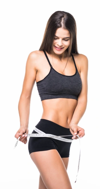young woman with beautiful body measuring thigh with measurement