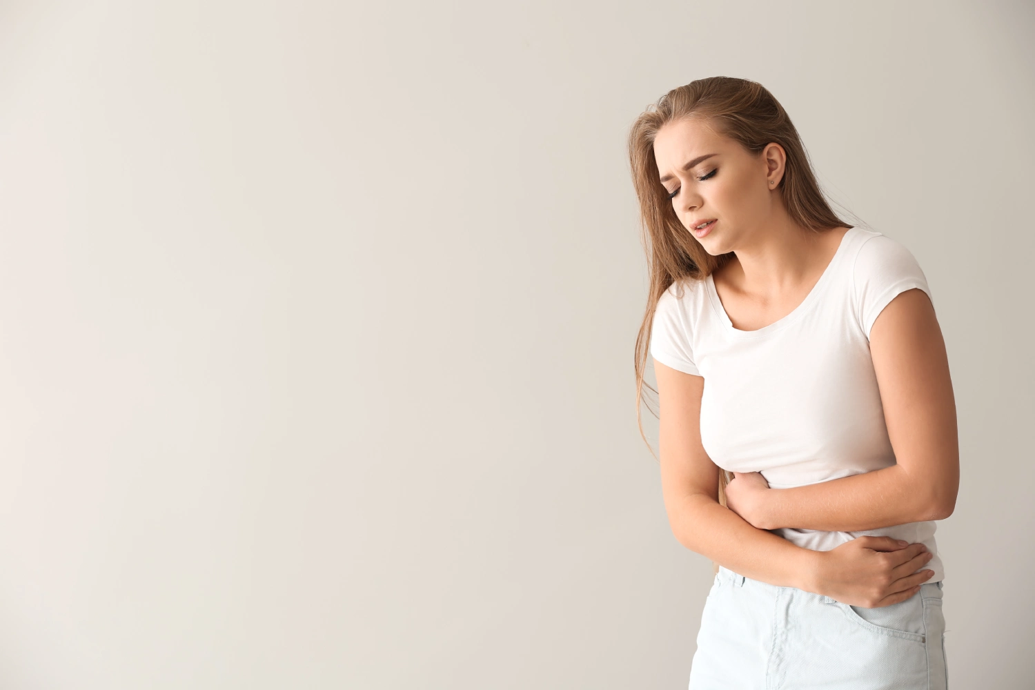 Young woman suffering from abdominal pain